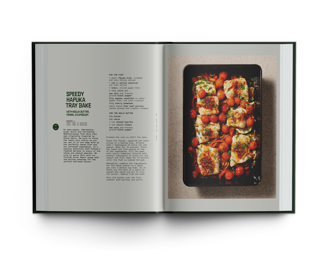 Open cookbook showing a Hapuka/fish recipe with a photograph of a dish on a white background