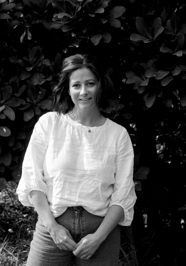 Black and White image of Sarah Milne standing in a studio