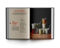 Open book showing a page with text and a photograph of drinks on a wooden surface.